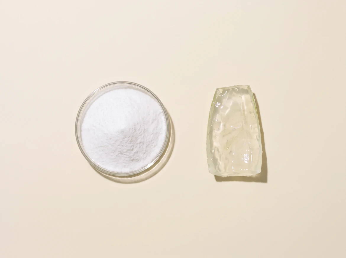 The crystalline powder and the aloe gel fillet side by side on flat cream